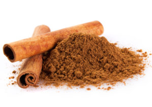 cinnamon sticks with powder isolated on white background